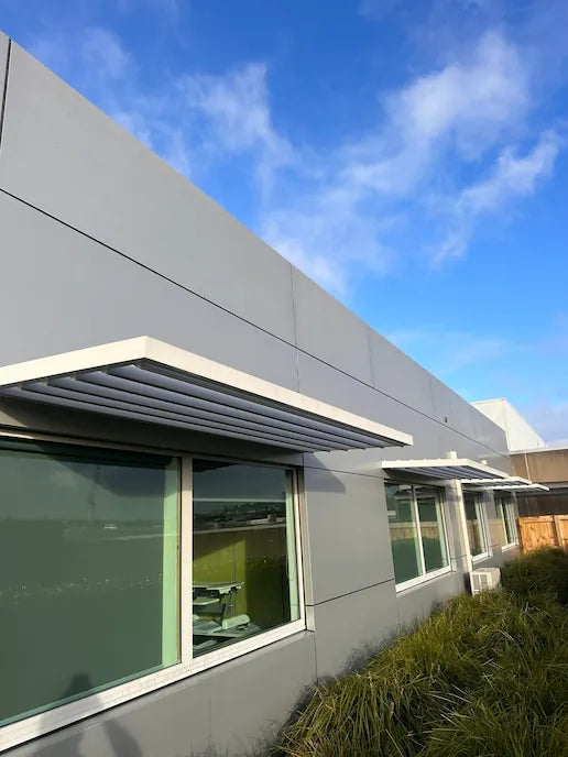 Commercial building facade and sunshade looking bright and spotless after professional signage-cleaning service.