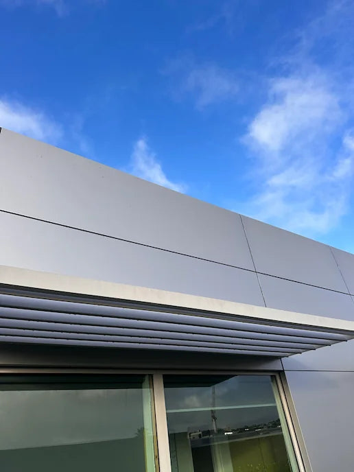 Close-up of a building's aluminium louvre and cladding looking bright and spotless after professional signage cleaning.